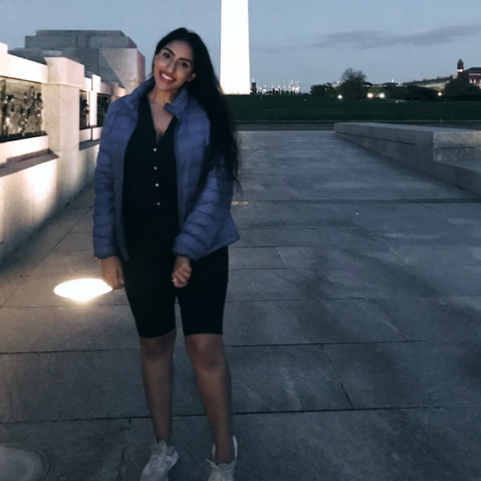 Young asian woman smiling and posing in front of the Washington Monument